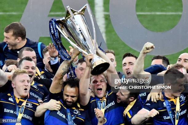 Leinster's players celebrate with the trophy after the 2018 European Champions Cup final rugby union match between Racing 92 and Leinster at the San...