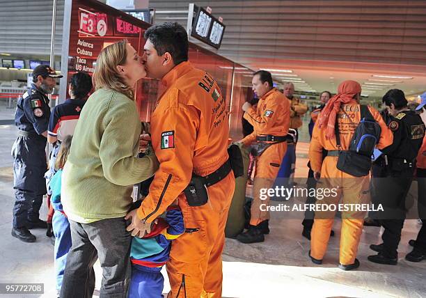 Mexican rescuer Luis Alba kisses his wife before departing to Haiti with Mexican disaster relief team Topos Tlatelolco International Brigade on...