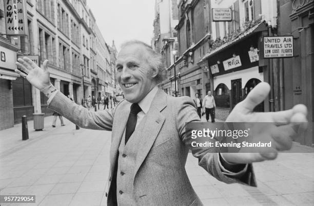 British actor, comedian and performer Bruce Forsyth outstretching his arms, London, UK, 3rd November 1977.