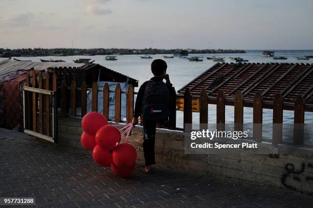 Child looks out at the sea at a fishing port on May 12, 2018 in Gaza City, Gaza. Tensions are high along the Gaza-Israel border following more than a...