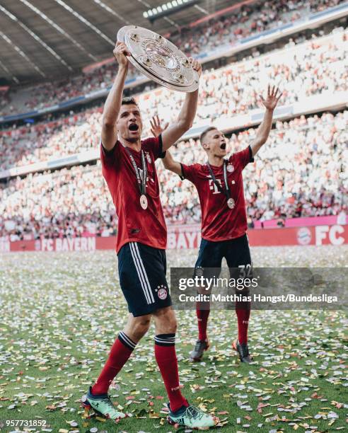 Thomas Mueller of FC Bayern Muenchen celebrates with the trophy Meisterschale after the Bundesliga match between FC Bayern Muenchen and VfB Stuttgart...