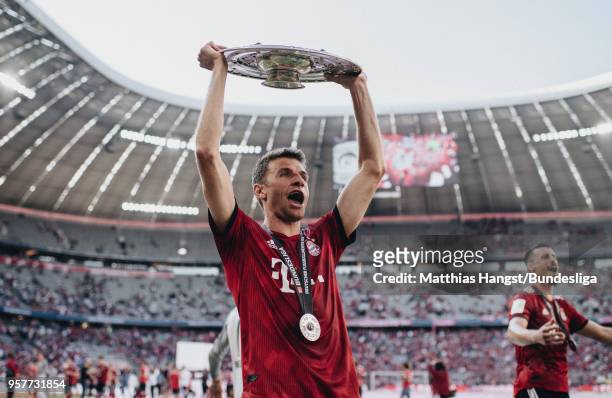 Thomas Mueller of FC Bayern Muenchen celebrates with the trophy Meisterschale after the Bundesliga match between FC Bayern Muenchen and VfB Stuttgart...