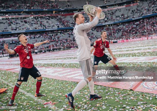 Goalkeeper Manuel Neuer of FC Bayern Muenchen celebrates with the trophy Meisterschale after the Bundesliga match between FC Bayern Muenchen and VfB...