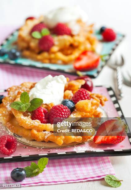 Funnel cakes with fresh berries and whipped cream.
