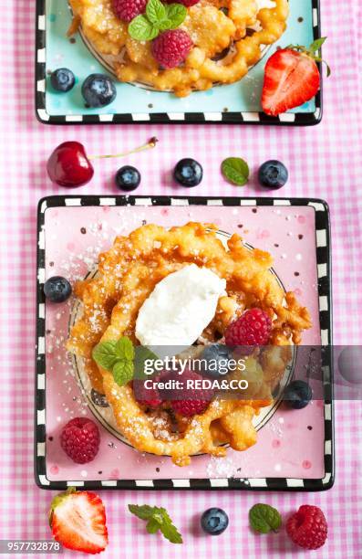 Funnel cakes with fresh berries and whipped cream.