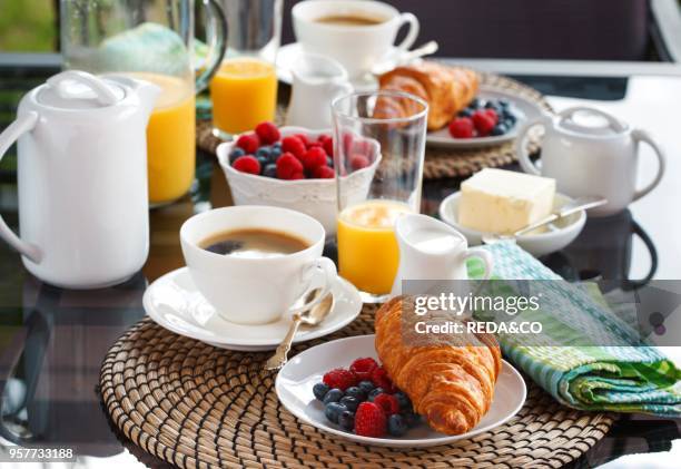 Breakfast with coffee and croissant on the open terrace.