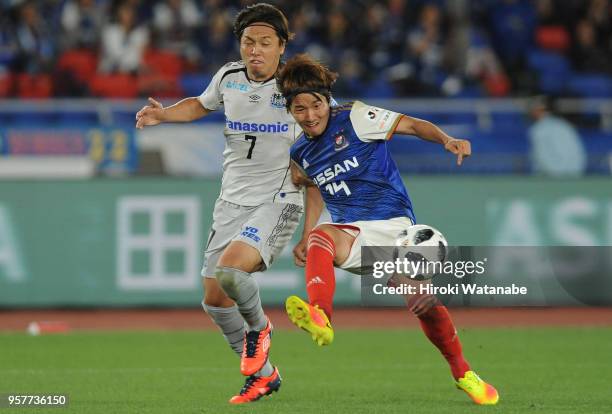 Yasuhito Endo of Gamba Osaka and Jun Amano of Yokohama F.Marinos compete for the ball during the J.League J1 match between Yokohama F.Marinos and...