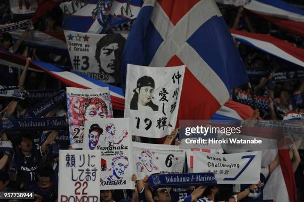 Fans of Yokohama F.Marinos cheer during the J.League J1 match between Yokohama F.Marinos and Gamba Osaka at Nissan Stadium on May 12, 2018 in...