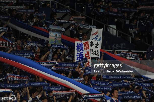 Fans of Yokohama F.Marinos cheer during the J.League J1 match between Yokohama F.Marinos and Gamba Osaka at Nissan Stadium on May 12, 2018 in...