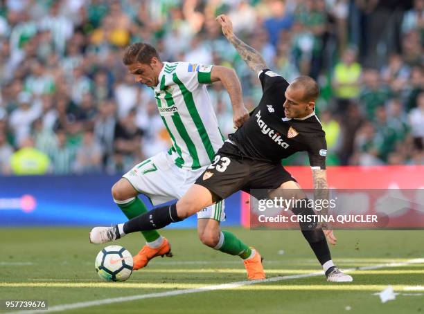 Real Betis' Spanish midfielder Joaquin fights for the ball with Sevilla's Spanish forward Sandro Ramirez during the Spanish league football match...