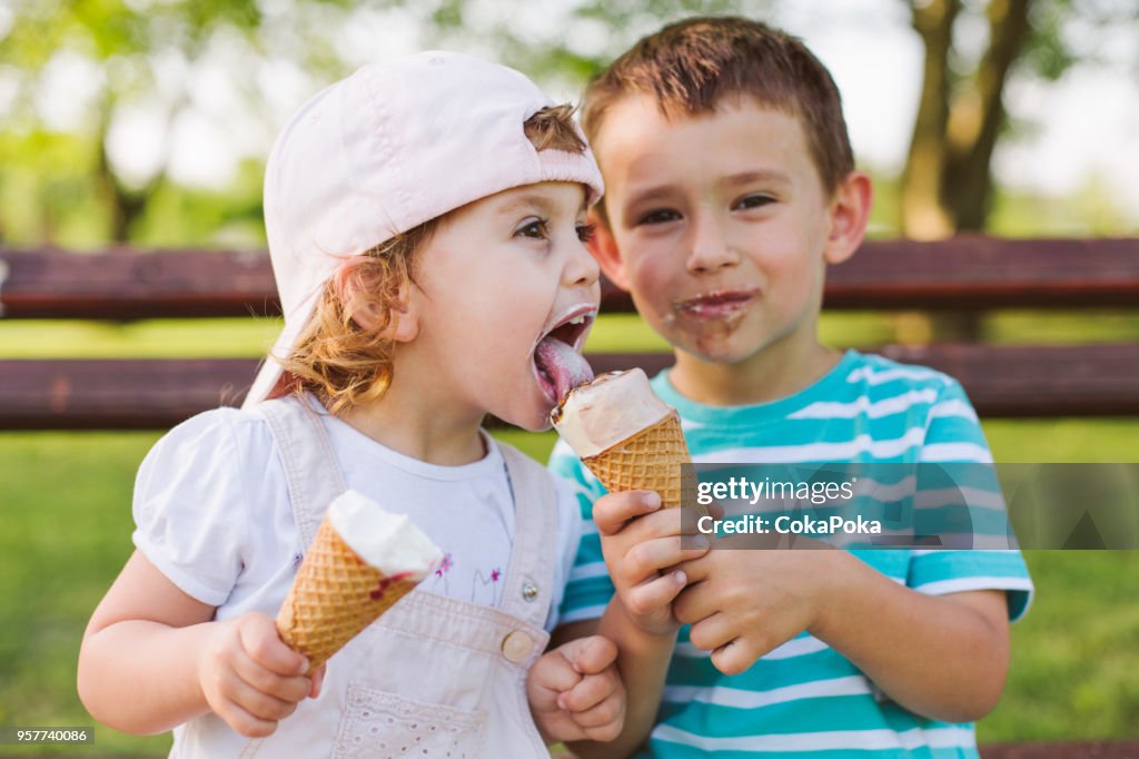 Boy share ice cream with his sister