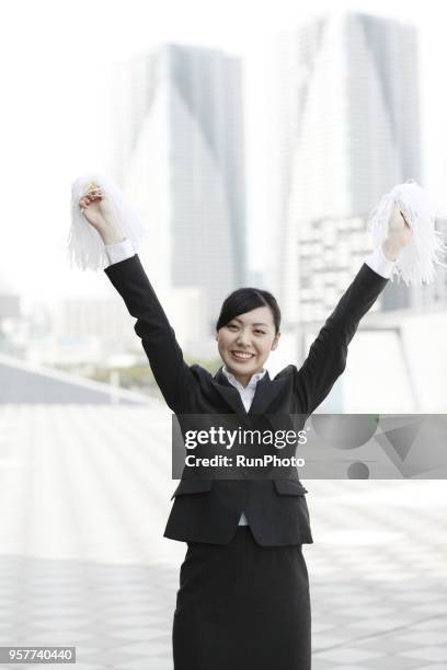businesswoman cheering with pompoms - asian cheerleaders stock-fotos und bilder