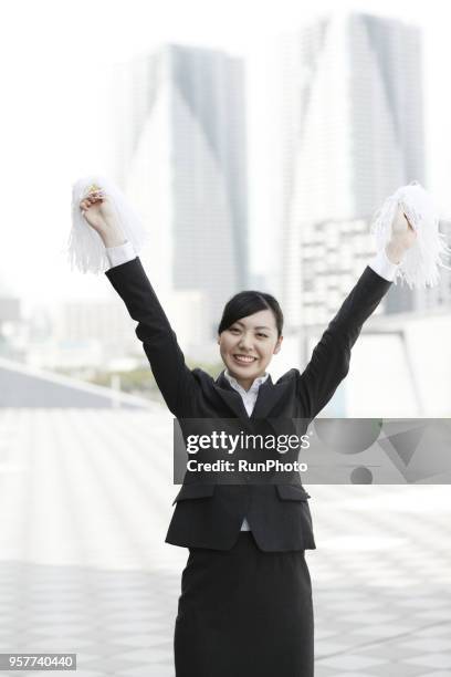 businesswoman cheering with pompoms - asian cheerleaders ストックフォトと画像