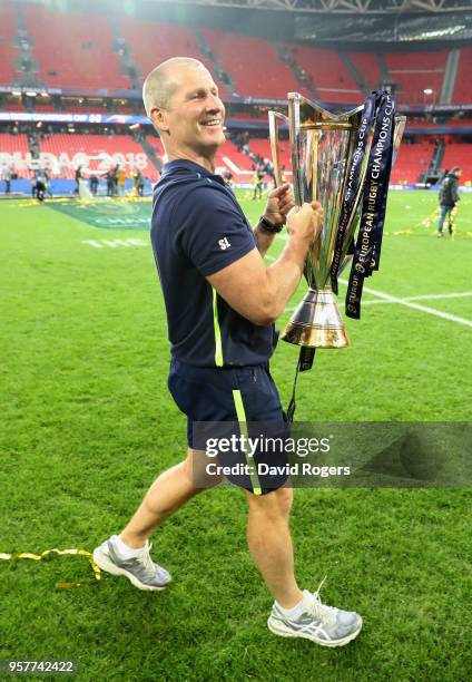 Stuart Lancaster, the Leinster assistant coach celebrates with the trophy after thier victory during the European Rugby Champions Cup Final match...