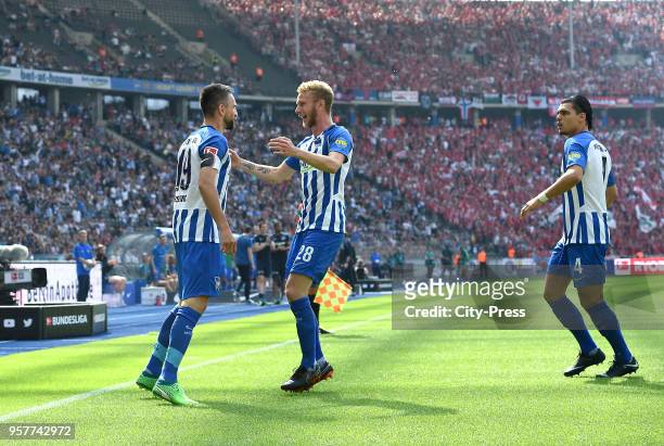 Vedad Ibisevic, Fabian Lustenberger and Karim Rekik of Hertha BSC celebrate after scoring the 1:1 during the Bundesliga game between Hertha BSC and...