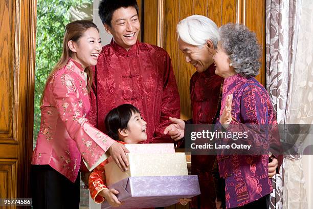 family bringing chinese new year gifts - cheongsam stock pictures, royalty-free photos & images