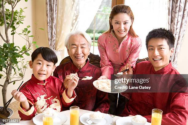 family having chinese dumplings - stereotypically upper class stock pictures, royalty-free photos & images