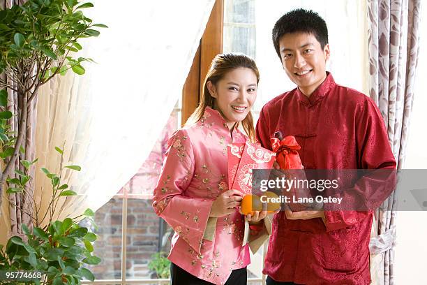 portrait of young couple in chinese new year - stereotypically upper class stock pictures, royalty-free photos & images