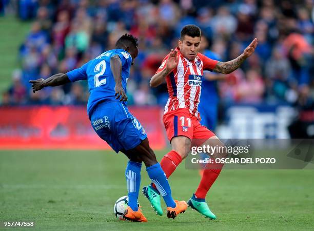 Atletico Madrid Argentenian's forward Correa vies with Getafe's defender Djene during the Spanish league football match between Getafe and Atletico...