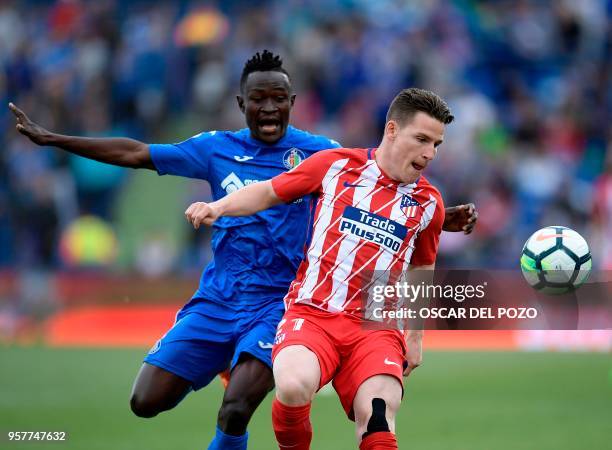 Atletico Madrid French's forward Gameiro vies with Getafe's defender Djene during the Spanish league football match between Getafe and Atletico...