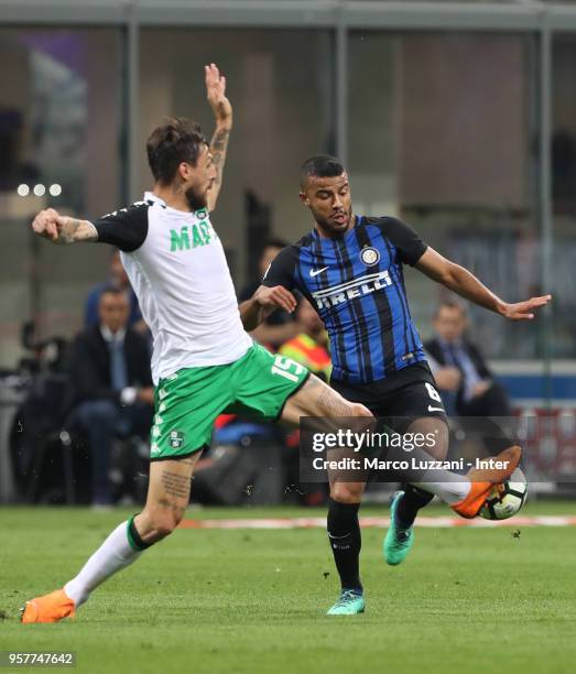 Rafinha of FC Internazionale competes for the ball with Francesco Acerbi of US Sassuolo during the serie A match between FC Internazionale and US...