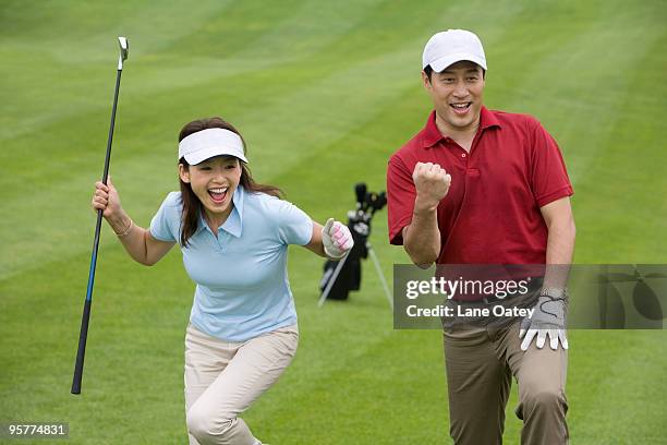 two golfers celebrating a great shot - celebrates exclusive sport cooperation stock pictures, royalty-free photos & images