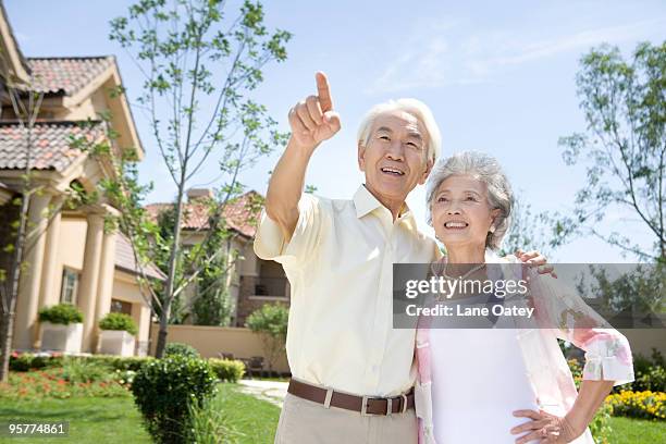 portrait of senior couple in front of house - stereotypically upper class stock pictures, royalty-free photos & images