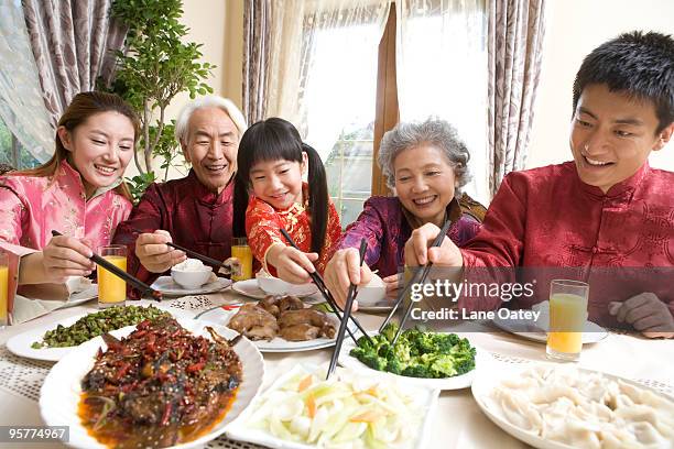 family having chinese new year dinner - luxury home dining table people lifestyle photography people stock pictures, royalty-free photos & images