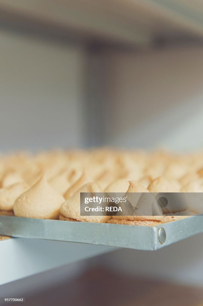 Pasticceria "trieste" Pastry Shop. Maiori. Amalfi Coast. Campania. Italy. in The Laboratory One of The Pastry Chef Deals with The Icing of "sospiri" (sights). Small Pastries Filled with Lemon Cream. Prepared By Hand Every Day. Italy. Europe