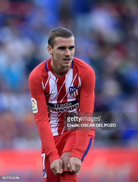 Atletico Madrid's French forward Antoine Griezmann stretches his sock during the Spanish league football match between Getafe CF vs Club Atletico de...