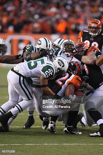 Halfback Cedric Benson of the Cincinnati Bengals is gang-tackled by Linebacker Bryan Thomas , Safety Kerry Rhodes and Defensive Tackle Howard Green...