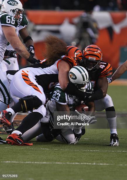 Defensive Tackle Domata Peko and Safety Chinedum Ndukwe of the Cincinnati Bengals make a stop of Running Back Shonn Greene of the New York Jets...