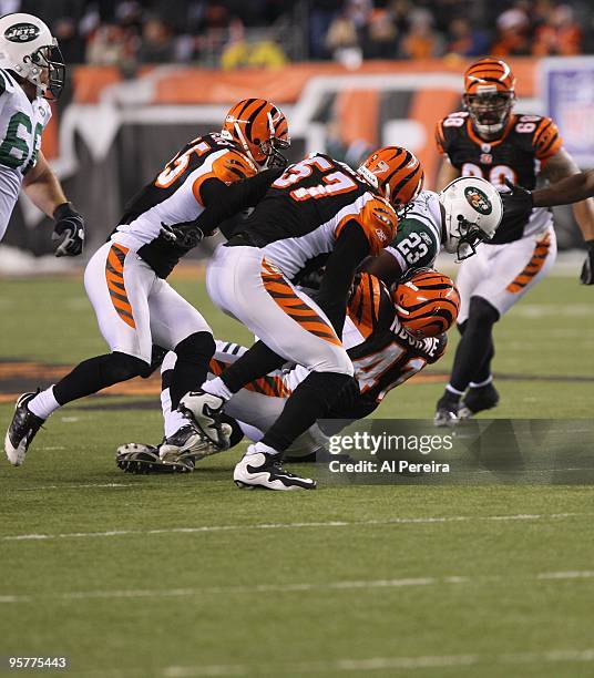 Safety Chinedum Ndukwe of the Cincinnati Bengals makes a stop of Running Back Shonn Greene of the New York Jets during their Wildcard Playoff game at...