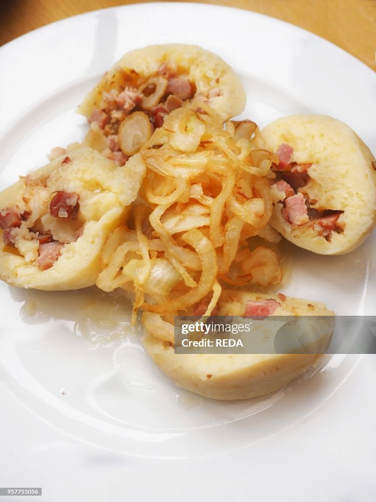Stuffed Potato Dumplings with Smoked Meat with Onion and Sauerkraut. Pilsner Urquell Original Restaurant Kulatak. Prague. Bohemia. Czech Republic. Europe