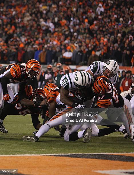 Linebacker Dhani Jones of the Cincinnati Bengals makes a stop of Running Back Thomas Jones of the New York Jets during their Wildcard Playoff game at...