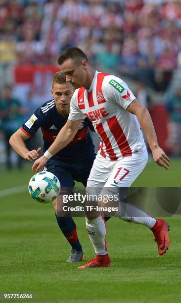 Joshua Kimmich of Muenchen and Christian Clemens of Koeln battle for the ball during the Bundesliga match between 1. FC Koeln and FC Bayern Muenchen...