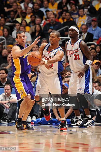 Sebastian Telfair of the Los Angeles Clippers passes the ball around Jordan Farmar of the Los Angeles Lakers during the game on January 6, 2010 at...