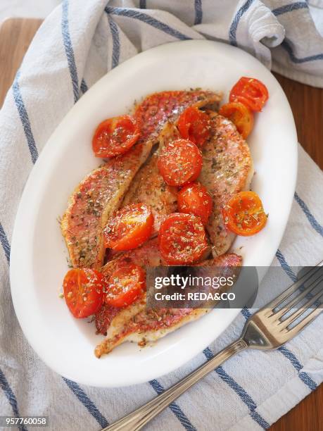 Red Mullet Fillets Cooked in a Pan with Cherry Tomatoes and Oregano. Italy. Europe.