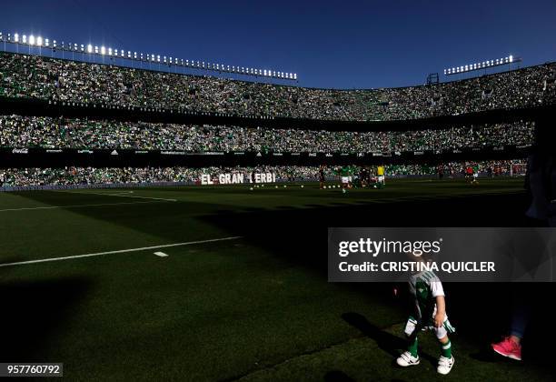 Child runs before the Spanish league football match between Real Betis and Sevilla at the Benito Villamarin stadium in Sevilla on May 12, 2018.