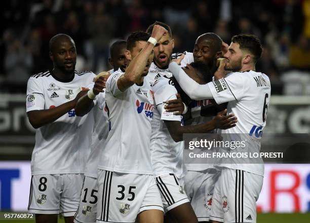 Amiens' Harisson Manzala is congratulated by teammates after scoring a goal during the French L1 football match between Amiens and Metz on May 12,...