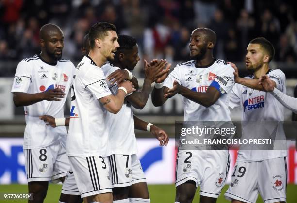 Amiens' Harisson Manzala is congratulated by teammates after scoring a goal during the French L1 football match between Amiens and Metz on May 12,...