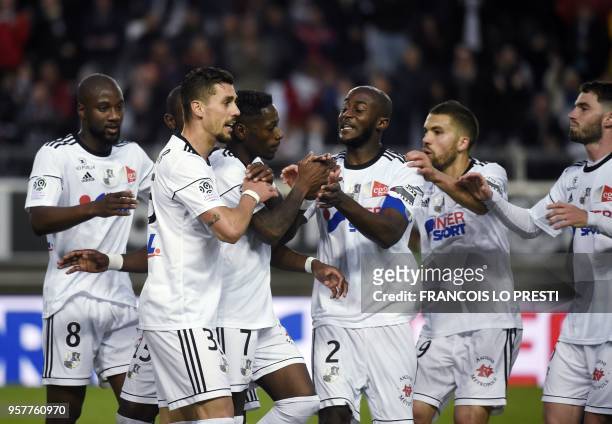 Amiens' Harisson Manzala is congratulated by teammates after scoring a goal during the French L1 football match between Amiens and Metz on May 12,...