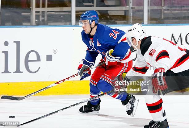 Ryan Callahan of the New York Rangers skates against Colin White of the New Jersey Devils in the first period on January 12, 2010 at Madison Square...
