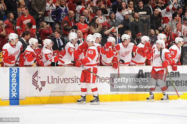 Darren Helm and Kris Draper of the Detroit Red Wings celebrate with the bench against the Los Angeles Kings on January 7, 2010 at Staples Center in...