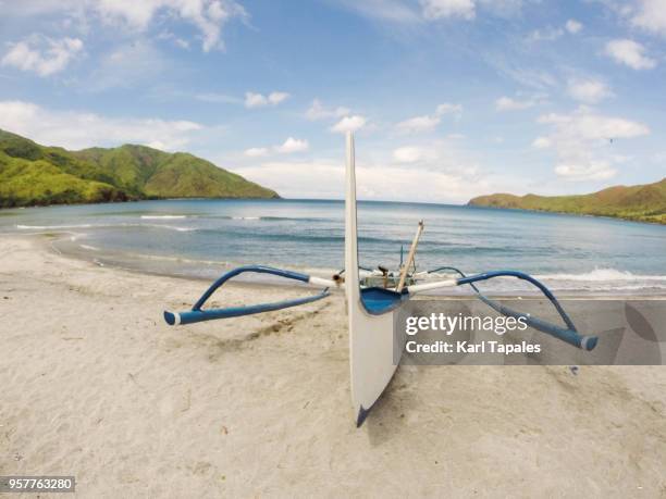 a white and blue boat on the beach - zambales province stock pictures, royalty-free photos & images