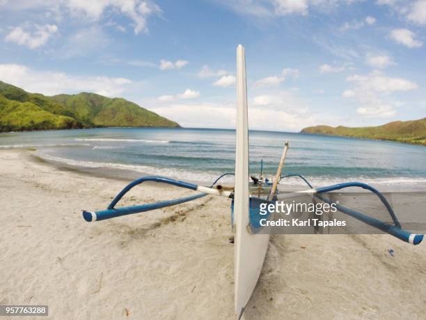 a white and blue boat on the beach - zambales province stock pictures, royalty-free photos & images