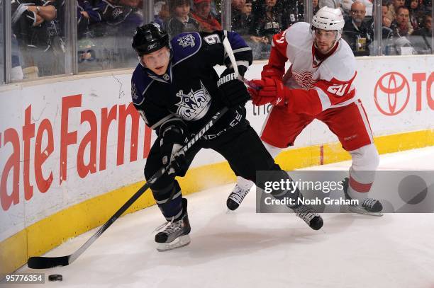 Oscar Moller of the Los Angeles Kings skates with the puck against Drew Miller of the Detroit Red Wings on January 7, 2010 at Staples Center in Los...