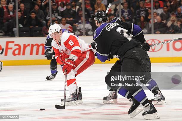 Justin Abdelkader of the Detroit Red Wings skates with the puck against Matt Greene of the Los Angeles Kings on January 7, 2010 at Staples Center in...