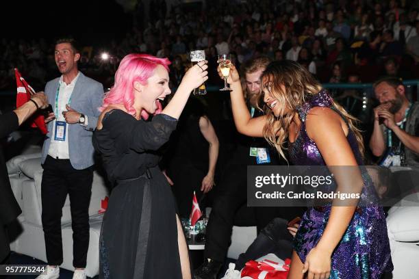 Claudia Pascoal of Portugal and Jessica Mauboy of Australia react in the green room during the Eurovision 2018 Grand Final at Altice Arena on May 12,...