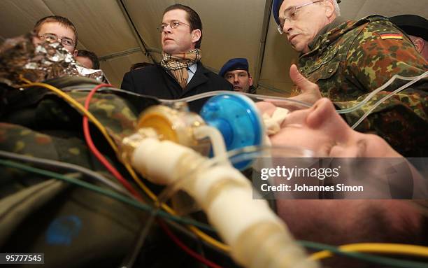 Military surgeon Lorenz Lampl explains the simulation of a surgical operation to German Defense Minister Karl-Theodor zu Guttenberg during his visit...